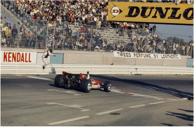 United States Grand Prix, Watkins Glen. Jochen Rindt (Lotus 49B-Ford), takes the chequered flag for his first Grand Prix victory by Anonymous - print