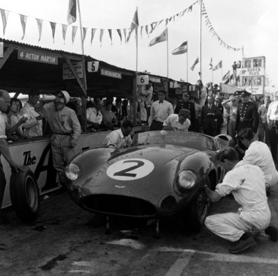 1959 RAC Tourist Trophy, Goodwood. Stirling Moss has a drink before climbing into his Aston Martin DBR1 by Anonymous - print