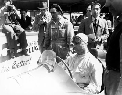 1950 British Grand Prix, Silverstone. Juan Manuel Fangio sits in his Alfa Romeo 158 at the first round of the new World Championship by Anonymous - print