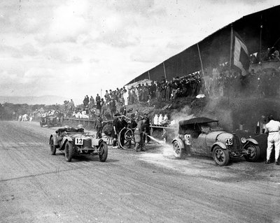 1928 RAC Tourist Trophy, Ards, Malcolm Campbell, Bugatti T43 on fire in the pits as Ian MacDonald's Rily passes by Anonymous - print