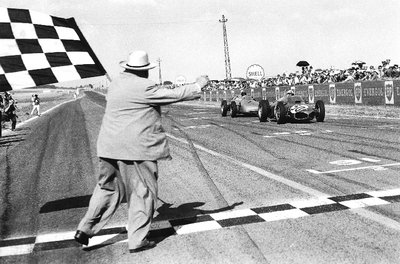 1961 French Grand Prix. Reims-Gueux, France. 30/6-2/7 1961. Giancarlo Baghetti (Ferrari 156) closely followed by Dan Gurney (Porsche 718), takes the chequered flag for 1st position and his maiden win on his Grand Prix debut by Anonymous - print