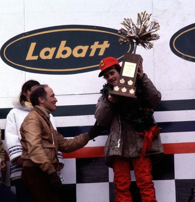 CANADIAN GP 1978 ILE NOTRE DAME CIRCUIT, MONTREALGILLES VILLENEUVE, FERRARI ACCEPTS THE WINNERS TROPHY FROM PRIME MINISTER OF CANADA, PIERRE TRUDE by Anonymous - print