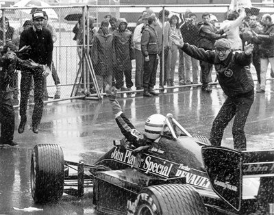 1985 Portuguese Grand Prix. Estoril, Portugal. 19-21 April 1985. Ayrton Senna (Lotus 97T-Renault) celebrates 1st position with Team Manager Peter Warr (right) in parc ferme. by Anonymous - print