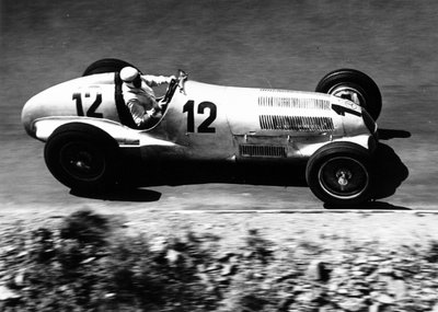 1937 German Grand Prix. Nurburgring, Germany. 25 July 1937. Rudolf Caracciola, Mercedes-Benz W125, 1st position, action. by Anonymous - print