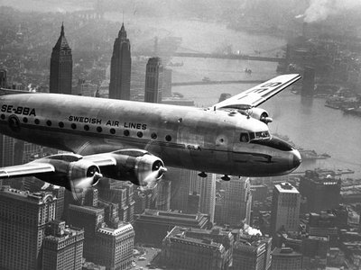 Aircraft Flying over City by Anon - print