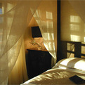 Bed-draped-in-natural-fiber-textiles-s