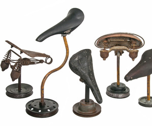 Group-of-5-vintage-bicycle-seats-mounted-on-rustic-stands-m
