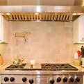 Pasta-pot-filler-faucet-on-tile-blacsplash-above-wolf-range-s