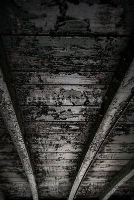 A background textured image of a burnt wooden train carriage roof.