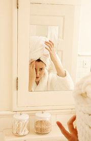 woman in bathroom getting ready