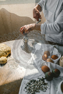 Woman Preparing Homemade Dough in the Kitchen and using a mincing machine. Preparation Raw Dough for Baking