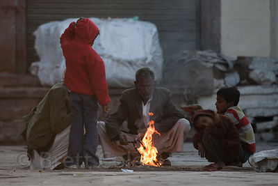 Warming up at a trash fire on a cold winter morning in Jodhpur, Rajasthan, India
