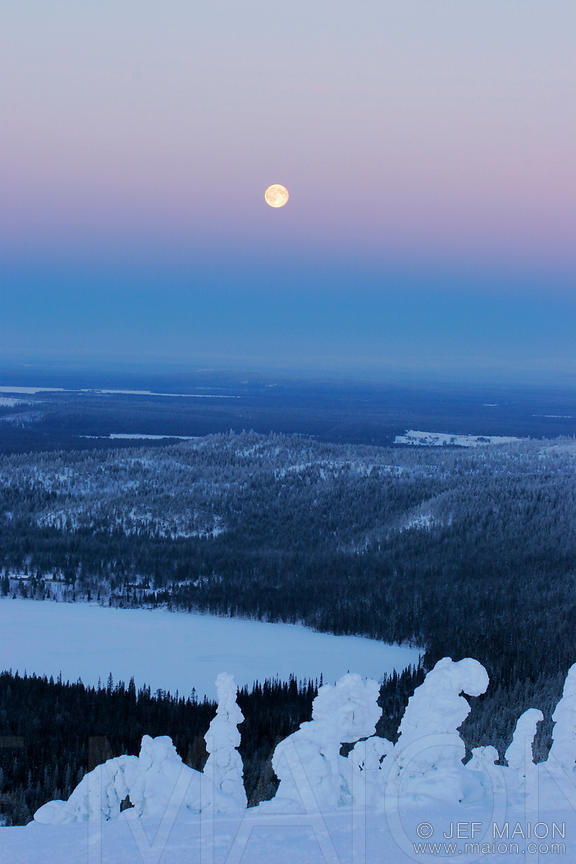 Full moon over winter landscape