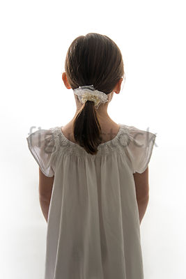 A Figurestock image of a little girl in a dress, from behind – shot from eye level.