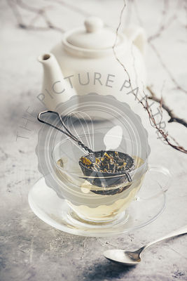 Tea composition with Cup of green tea and white teapot