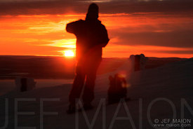 Hiker facing winter sun