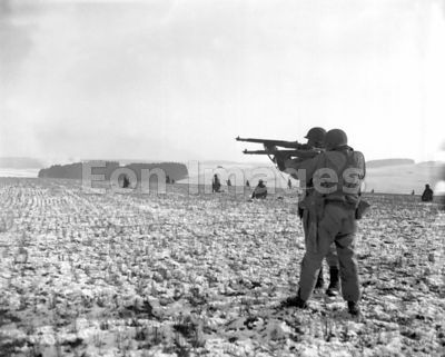 US infantrymen fire on Germans near Bastogne in Belgium