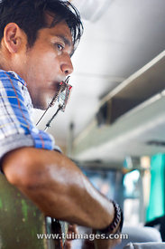 indonesian man busking by singing in the bus