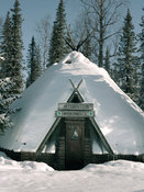 Wooden hut covered by snow