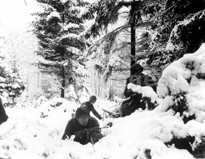 American soldiers fight in fresh snow during Battle of the Bulge