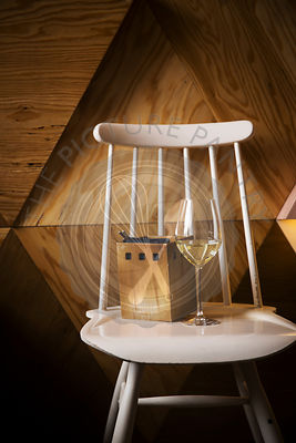 Glass of white wine standing on a vintage chair
