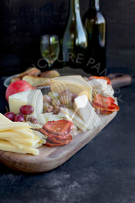 A cheese board of various cheese and crackers.