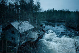 Old log house by river