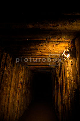 An atmospheric image of a darkly lit underground tunnel / bunker.