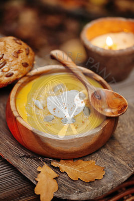 Pumpkin soup in a rustic bowl outside