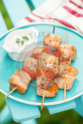 Grilled salmon kebabs with cherry tomatoes and garlic sauce