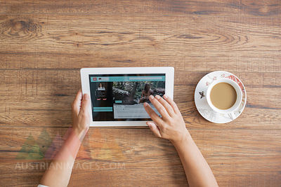 Hands of woman using tablet, top view