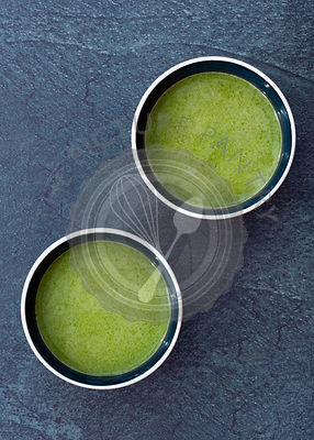 Matcha green tea in two small Japanese cups.