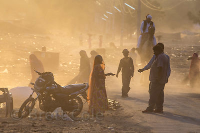 Women sweep up and burn garbage on a dusty desert road after the Pushkar Camel Fair, Pushkar, Rajasthan, India. Air pollution is an epidemic health crisis across India. India has the worst air pollution in the world, worse even than China, with Delhi the #1 worst city in the world.