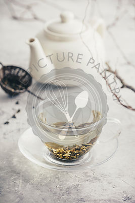 Tea composition with Cup of green tea and white teapot