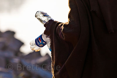 Elderly man collecting plastic trash at Gadi Sagar lake in Jaisalmer, Rajasthan, India