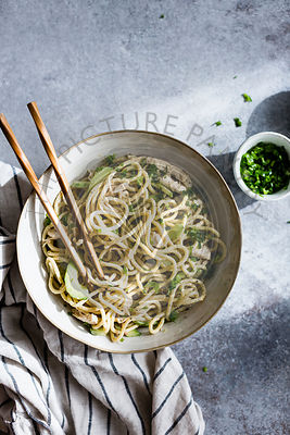 An Asian noodle salad in a ceramic bowl