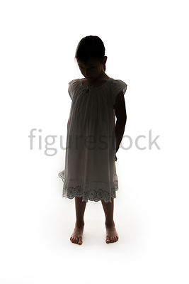 A Figurestock image of a little girl, in silhouette, in a night dress, looking down – shot from eye level.