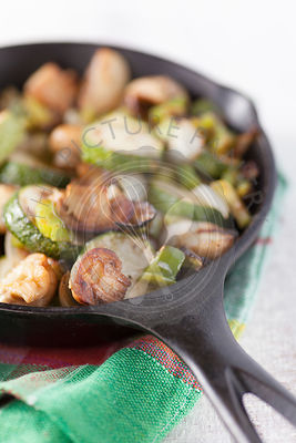 Mini Portobello Mushrooms Sauteed Green Zucchinies and garnished with pine nuts