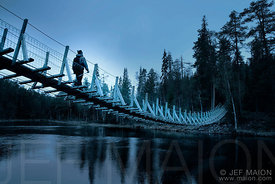Hiker on suspended bridge