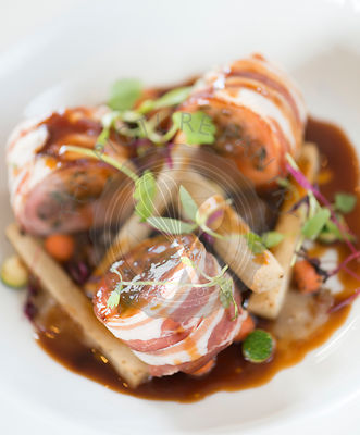 Baked loin of rabbit and pancetta. Chestnut and sage stuffing, shallot puree and Dijon mustard sauce.