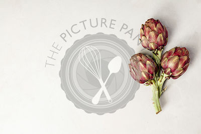 Top view of artichokes on concrete background