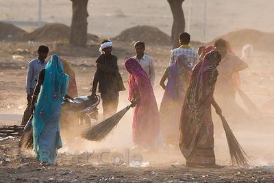Women sweep up and burn garbage on a dusty desert road after the Pushkar Camel Fair, Pushkar, Rajasthan, India. Air pollution is an epidemic health crisis across India. India has the worst air pollution in the world, worse even than China, with Delhi the #1 worst city in the world.