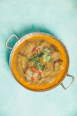 Traditional curry on blue background. Flat lay