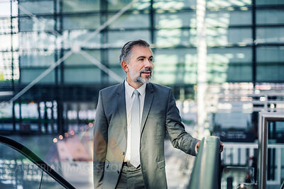 Businessman on escalator