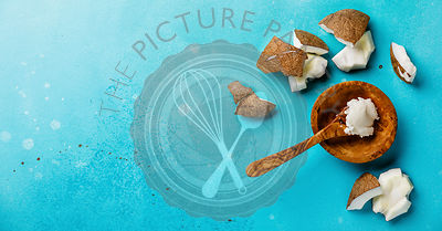 Organic healthy Coconut butter and fresh coconut pieces on bue background copy space