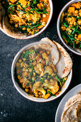 Cauliflower sweet potato curry with arugula and naan.