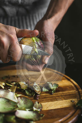 A man preparing an artichoke