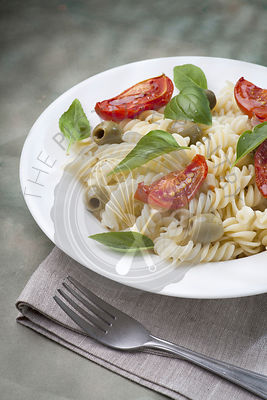 Pasta with baked tomatoes and green olives