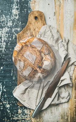 Flat-lay of sourdough wheat bread over linen napkin