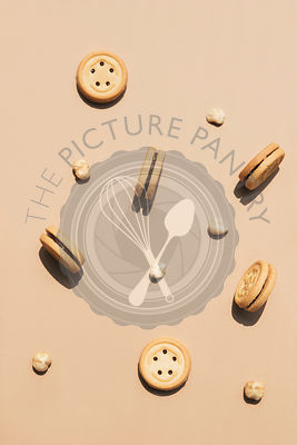 Round walnut cookies on a caramel coloured background.